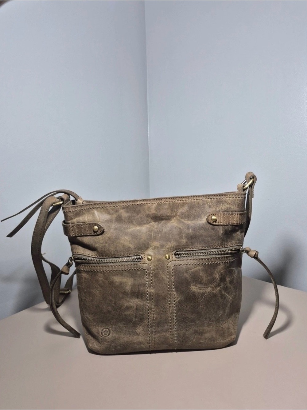 Borne Distressed Leather in taupe with Front Zip Pockets
